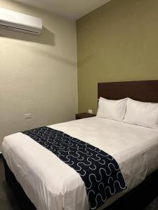 Giường trong phòng chung tại REGMAR Progreso Yucatán