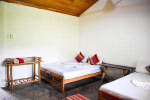 En eller flere senge i et værelse på Extream Adventures of Sri Lanka