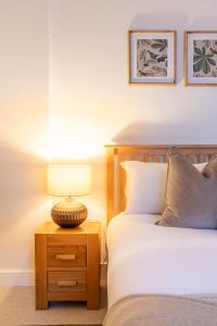 a bedroom with a bed and a lamp on a night stand at The Tartan Terrace in Inverness