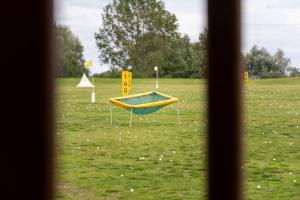 a view from a window of a park with a playground at Tranquil Country Retreat With Access to Gym, Golf & Spa in Deanshanger