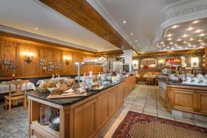 a large kitchen with a counter with food on it at Hotel Zauchensee Zentral in Zauchensee