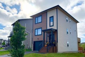 a large house with a blue door at Luxury Home with Gym, Sauna, Patio, and AC in Halifax