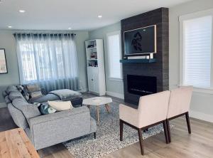 a living room with a couch and a fireplace at Luxury Home with Gym, Sauna, Patio, and AC in Halifax