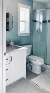 a bathroom with a toilet and a glass shower at Luxury Home with Gym, Sauna, Patio, and AC in Halifax