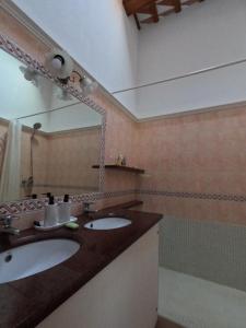 a bathroom with two sinks and a mirror and a shower at Amazing villa for big groups in the best place of Costa Brava in Palamós +24 photos