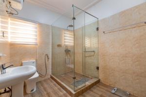 a bathroom with a shower and a sink at Tastefully Furnished 3 Bedroom apartment in Lekki