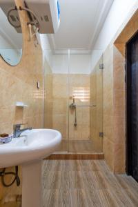 a bathroom with a sink and a shower at Tastefully Furnished 3 Bedroom apartment in Lekki