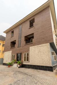 a brown building with windows and plants at Tastefully Furnished 3 Bedroom apartment in Lekki