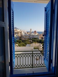 an open window with a view of a city at Nikos Hotel in Diafani