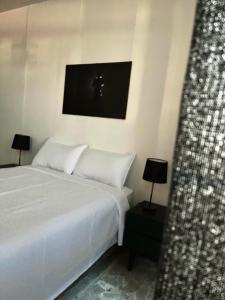 a bedroom with a bed and a tv on the wall at La casona del Centro Hist. in Querétaro