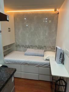 a small room with a small bed in a room at Sleep Cubee Hostel in Hong Kong