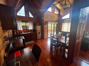a kitchen and living room with a table and a dining room at Pura Vida Cabinita in Uvita