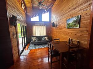 a dining room with a table and a couch at Pura Vida Cabinita in Uvita