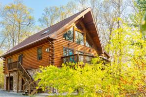 a log cabin in the woods with a staircase at Lake, Kayaks & Sauna - Family & Wellness in Otis