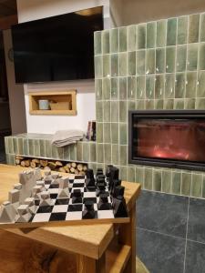 a chess board on a table in front of a fireplace at Roubenka Sobotín in Sobotín