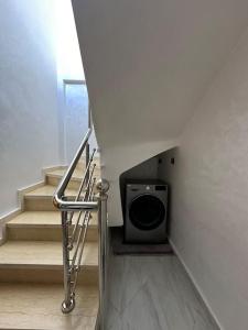 a stairwell with a speaker in a room with stairs at Al Hoceima Mini Villa in Al Hoceïma