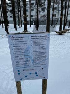 a sign in the snow in a park at Luxurious Specious appartment in Pyussi