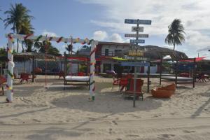 a playground on the beach with tables and chairs at Relais de Charme Boutique Hotel Pititinga in Rio do Fogo