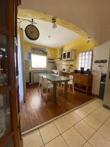 a kitchen with a table and a dining room at lé z'orangines in Saint-Benoît