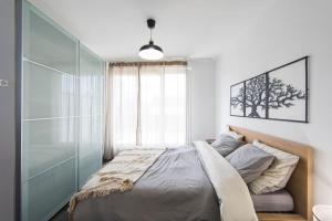 a bedroom with a bed and a large window at Appartement grande terrasse proche de Tours centre in Tours