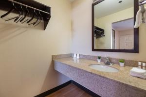 a bathroom with a sink and a mirror at Sacramento Inn & Suites in Sacramento