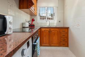 a kitchen with a sink and a counter top at Apartamento en S agaró zona tranquila in S'agaro
