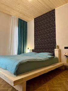 1 dormitorio con 1 cama con marco de madera en In The Forest, en Mestia