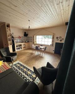 a living room with a table and chairs in a room at In The Forest in Mestia