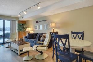 a living room with a couch and a table at 117D Edgewater Inn in Charlevoix