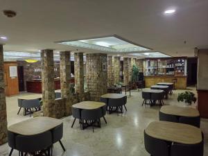 a restaurant with tables and chairs in a room at PIA Hotel Bandung in Bandung +23 photos