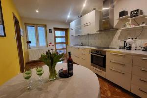 a kitchen with a table with wine glasses on it at Apartmán u Aničky in Banská Bystrica