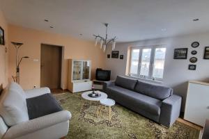 a living room with a couch and a table at Apartmán u Aničky in Banská Bystrica