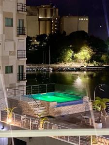 a swimming pool in the middle of a river at night at Apartamento Frente a la Zona Colonial, Santo Domingo in Santo Domingo