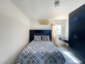 a bedroom with a blue and white bed and a desk at Comfortable family friendly Home 133 in Puerto Peñasco