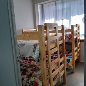 a bedroom with two bunk beds and a window at TRASHAVEN - Seaside Haven Backpackers in Durban