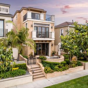 an exterior view of a house with stairs and trees at New Luxurious Beach Home in Huntington Beach