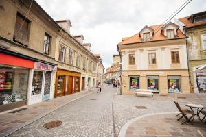 an empty street in a city with buildings at Primus apartments in Ljubljana