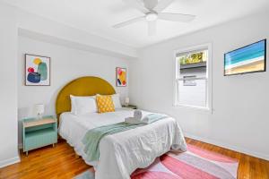 a white bedroom with a bed and a window at Fire Pit + Grill + 2MI to DT Orlando in Orlando