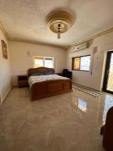 a bedroom with a bed and a ceiling at Northern View in Kafr Khall