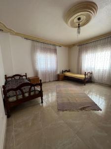 a large room with two beds and a window at Northern View in Kafr Khall
