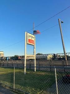 a sign for a motel on the side of a fence at Sportsman Motel in Malta