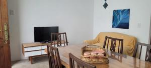 a dining room with a table with a basket on it at APARTAMENTOS FRERS in Martínez
