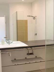 a bathroom with a sink and a mirror at Large Modern 3BR 2 BATH Apt for Big Groups in Fyshwick