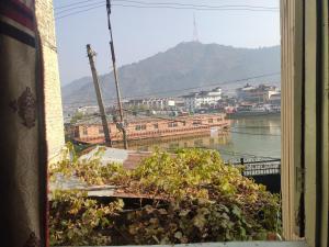 a window with a view of a river and buildings at Lake Boulevard Guest House in Durgjan