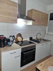 a kitchen with a black and white stove top oven at Weserbergland Apartment in Bodenwerder