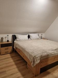 a bedroom with a bed and a night stand at Weserbergland Apartment in Bodenwerder