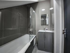 un baño con bañera y lavabo en SuperValue Suite 6 - Fast WiFi, Hotel Linen, Keyless Entry, City only 10 Mins - BY PROPERTY PROMISE, en Cardiff