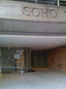 a building with a sign on the side of it at Palermo Soho Apartamento in Buenos Aires