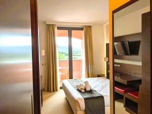 a hotel room with a bed and a balcony at Hotel Il Gentiluomo in Arezzo