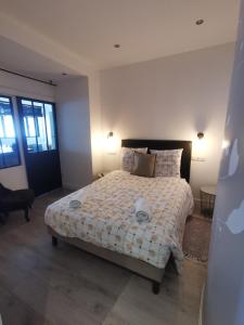 a bedroom with a bed with a white comforter at Le petit Brooklyn in Strasbourg +22 photos